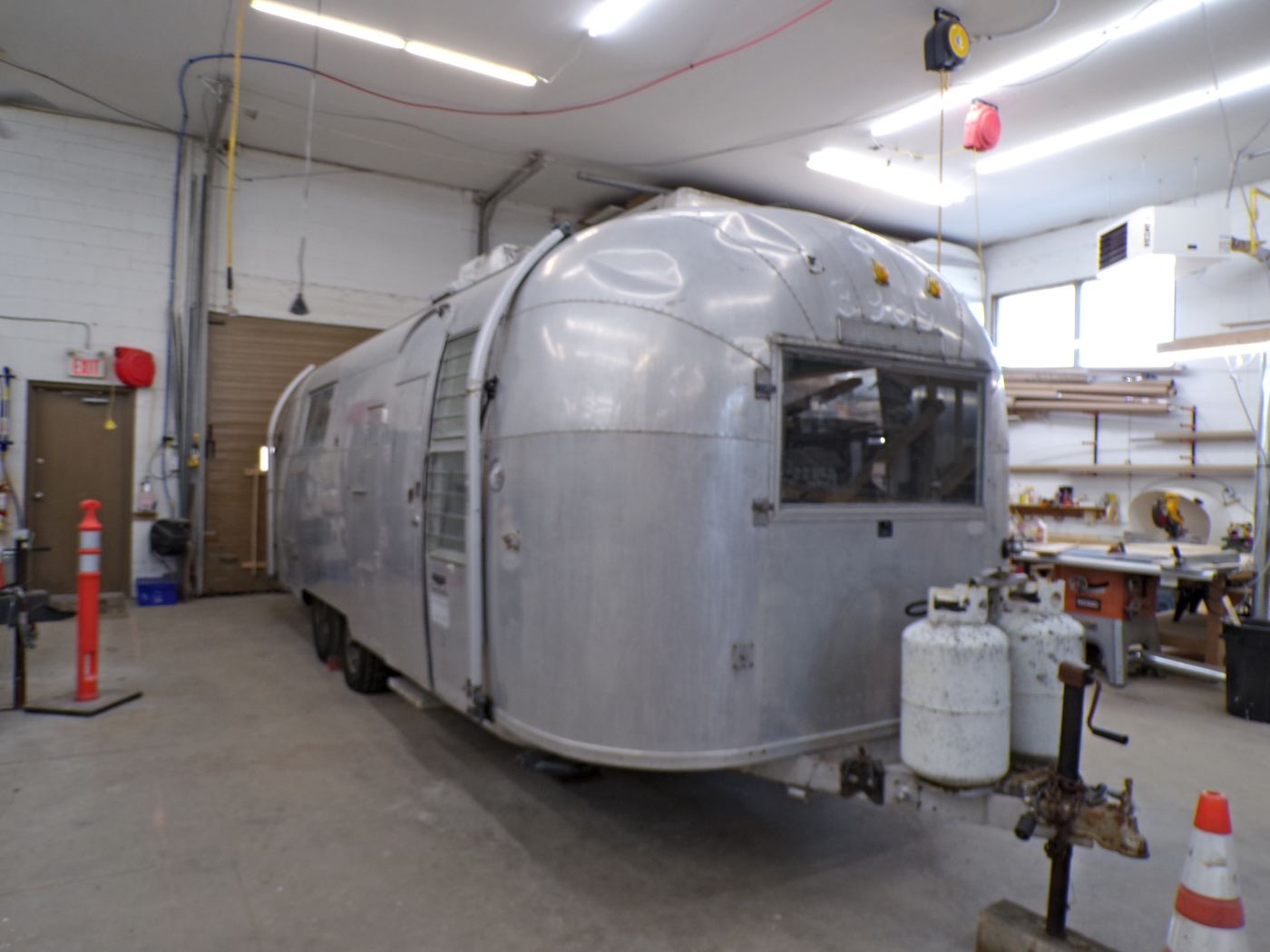 An Airstream midway through a structural restoration on the shop floor.